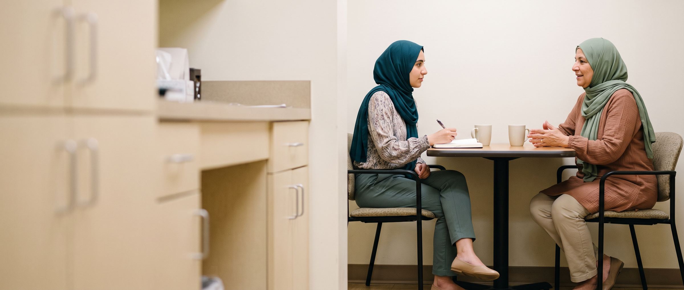A senior physician mentoring a medical student over coffee